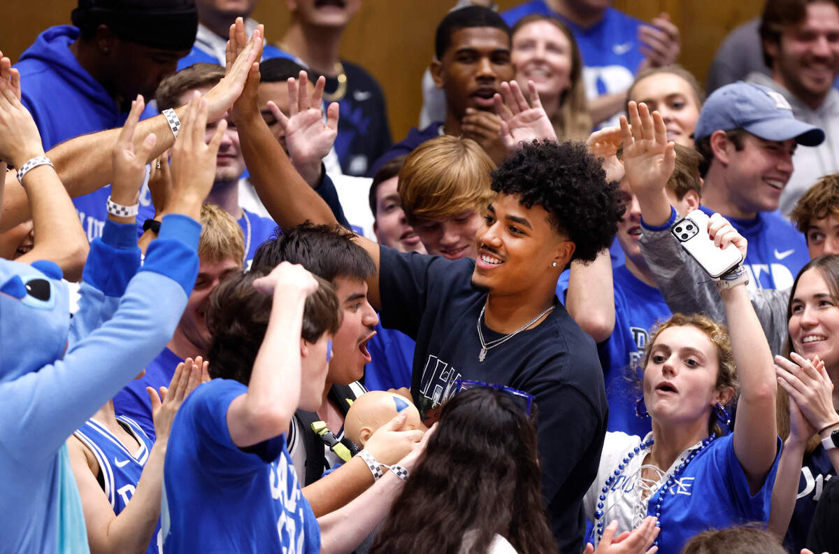Quarterback Darian Mensah stands with Cameron Crazies during the second half of Duke 72-46 victory over Incarnate Word at Cameron Indoor Stadium in Durham, N.C., Tuesday, Dec. 10, 2024.