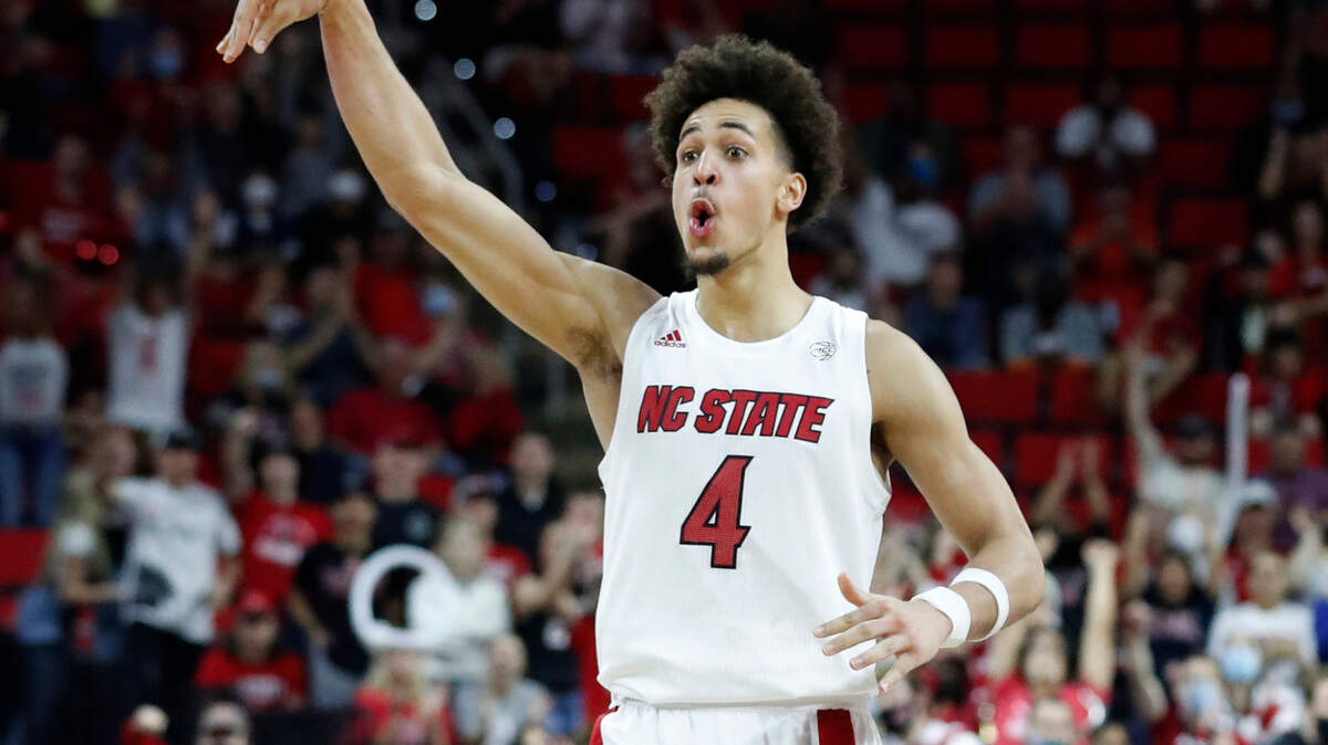 N.C. State’s Jericole Hellems (4) celebrates making a three-pointer during the second half of Louisville’s 73-68 victory over N.C. State at PNC Arena in Raleigh, N.C., Saturday Dec. 4, 2021.