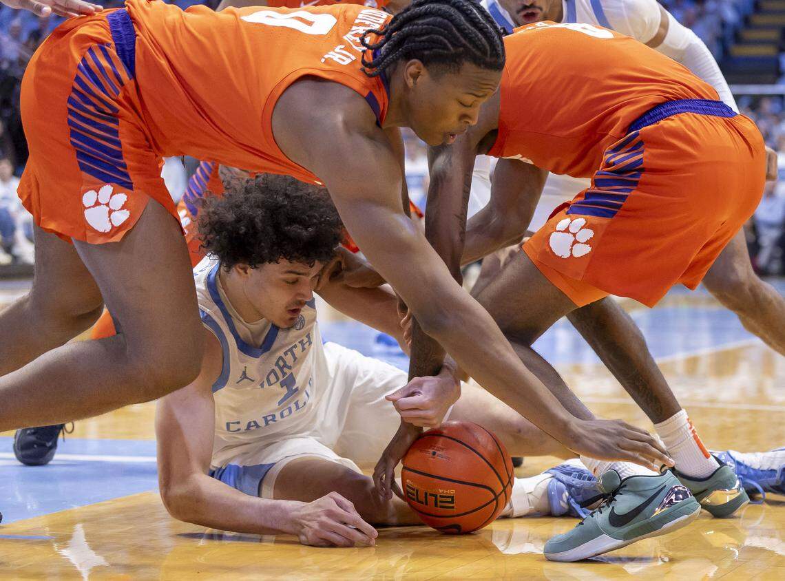 Clemson forward R J Godfrey (0) and forward Dallas Thomas (8) battle to recover the ball with North Carolina forward Zayden High (1) in the first half on Tuesday, March 3, 2026 at the Smith Center in Chapel Hill, N.C.