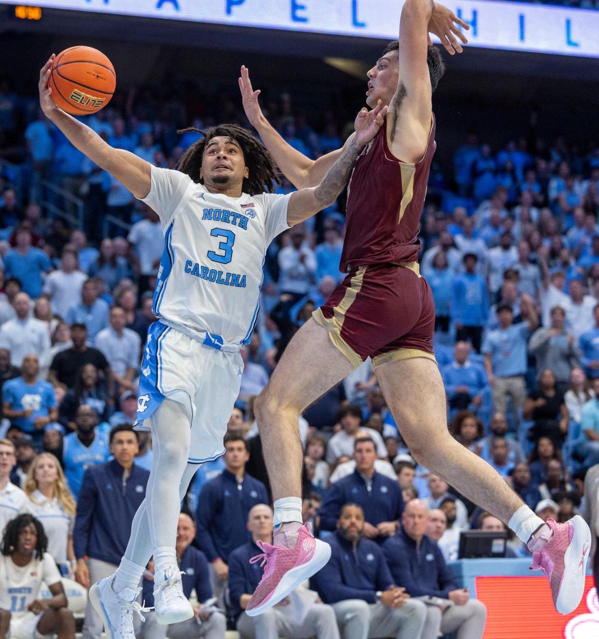 North Carolina guard Elliot Cadeau (3) draws a foul from Elon’s Sam Sherry (4) during the second half on Monday, November 4, 2024 at the Smith Center in Chapel Hill, N.C.