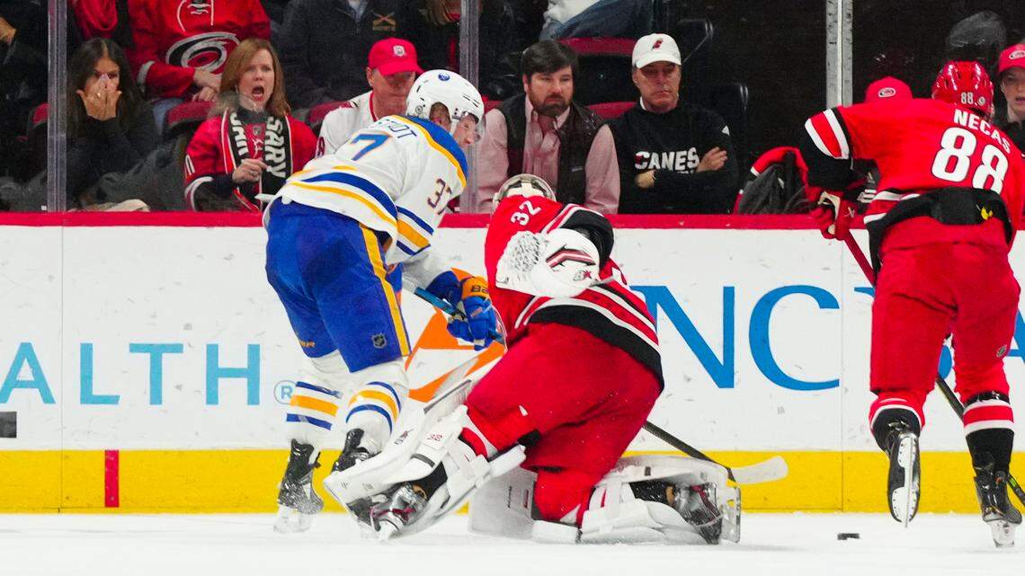Buffalo Sabres center Casey Mittelstadt (37) slips the puck in front of the net past Carolina Hurricanes goaltender Antti Raanta (32) during the third period at PNC Arena.