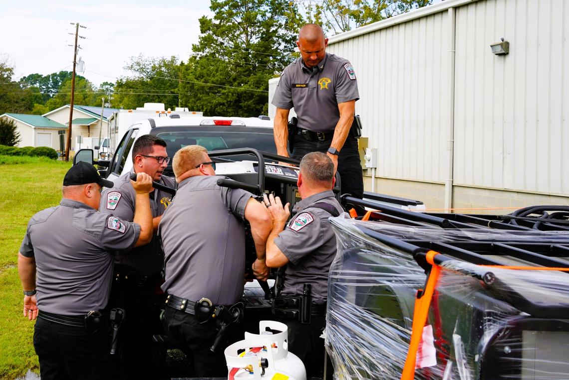 Four Chatham County Sheriff’s Office deputies and a captain loaded generators, bottled water, ready-to-eat meals and cans of gas before leaving Pittsboro on Monday, Sept. 30, 2024, to join the storm recovery effort in Yancey County.