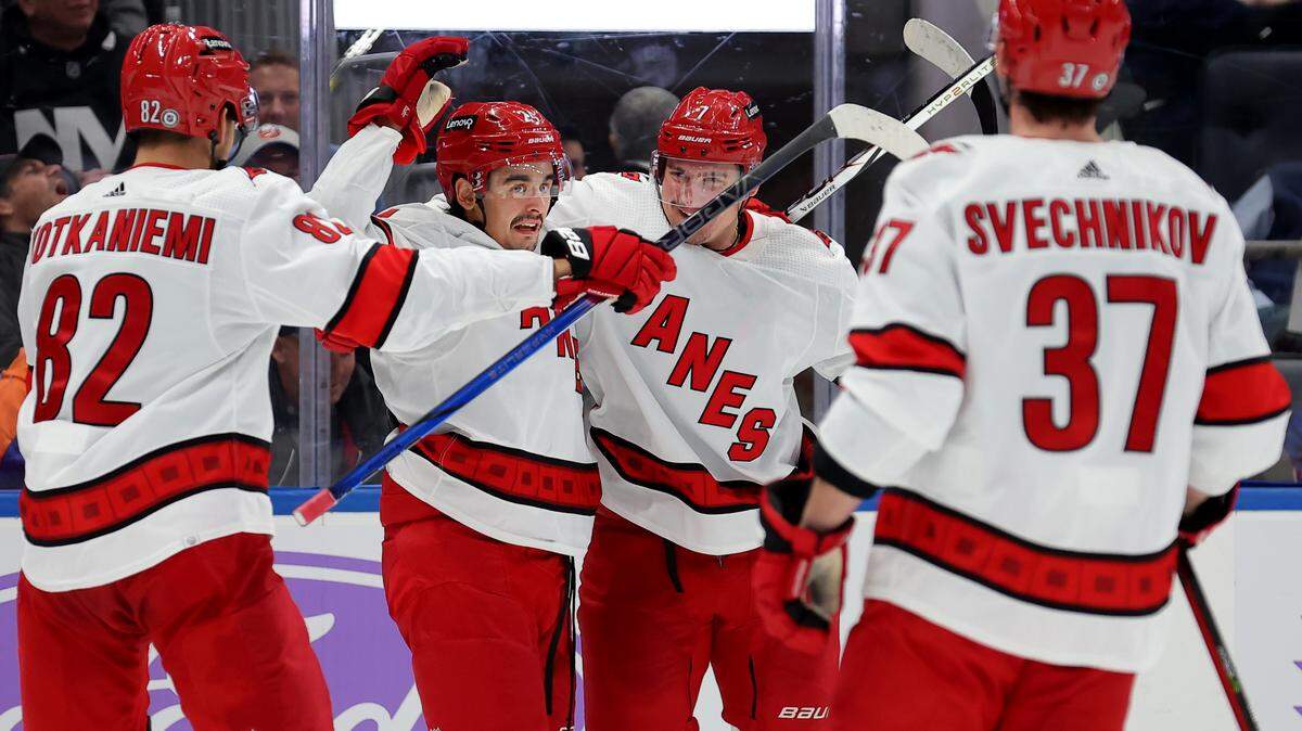 Nov 4, 2023; Elmont, New York, USA; Carolina Hurricanes defenseman Dmitry Orlov (7) celebrates his goal against the New York Islanders with centers Jesperi Kotkaniemi (82) and Seth Jarvis (24) and right wing Andrei Svechnikov (37) during the third period at UBS Arena. Mandatory Credit: Brad Penner-USA TODAY Sports