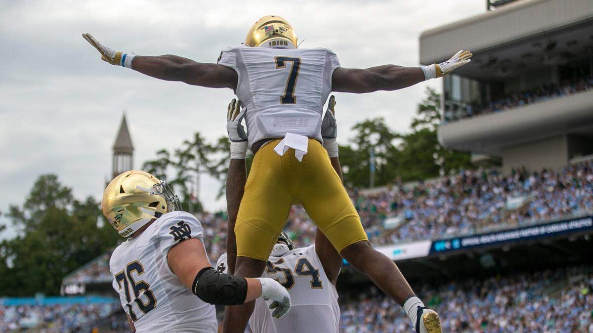Notre Dame’s Audric Estime (7) celebrates with Jacob Lacey (54) and Joe Alt (76) after scoring a touchdown on a one-yard run to give the Irish a 21-14 lead over North Carolina in the second quarter on Saturday, September 24, 2022 at Kenan Stadium in Chapel Hill, N.C.