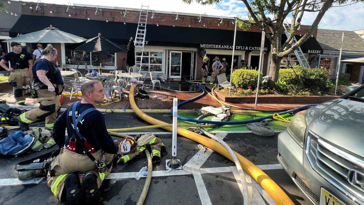 Chapel Hill firefighters battle a blaze at Mediterranean Deli in the 400 block of Franklin Street Saturday, July 22, 2023.