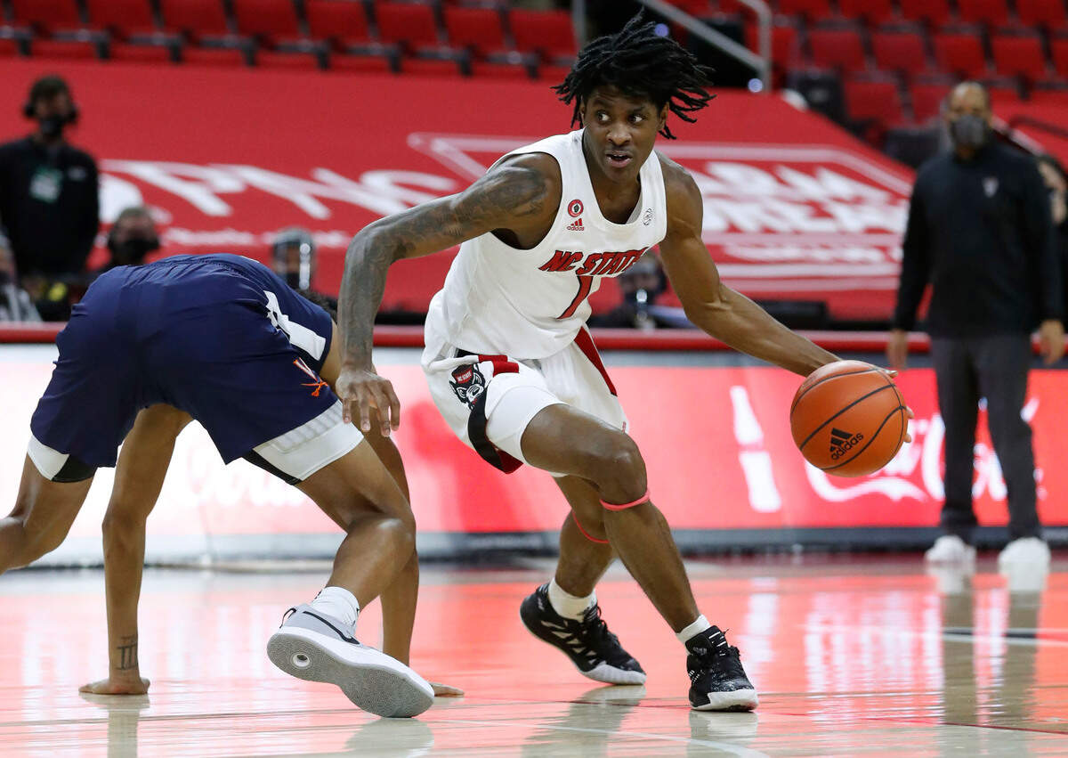 N.C. State’s Dereon Seabron (1) gets around Virginia’s Trey Murphy III (25) during the first half of N.C. State’s game against Virginia at PNC Arena in Raleigh, N.C., Wednesday, February 3, 2021.