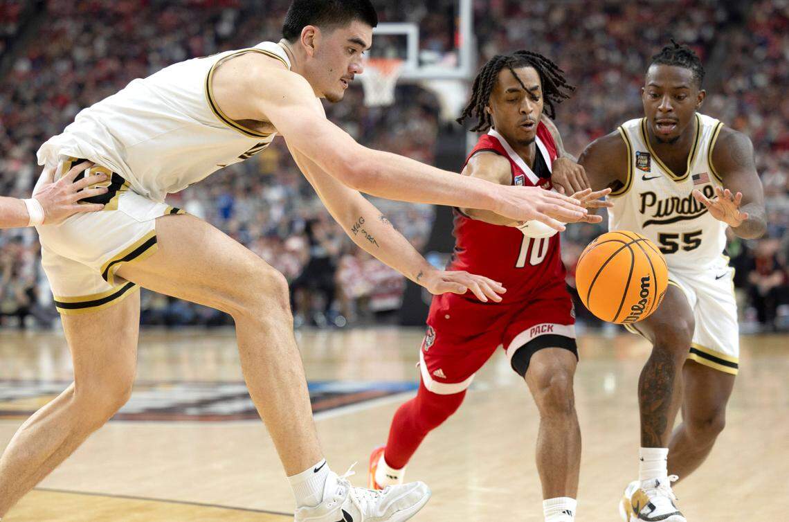 Purdue’s Zach Edey (15), Lance Jones (55) and N.C. State’s Breon Pass (10), battle for a loose ball in the second half during the NCAA Final Four National Semifinal game on Saturday, April 6, 2024 at State Farm Stadium in Glendale, AZ.
