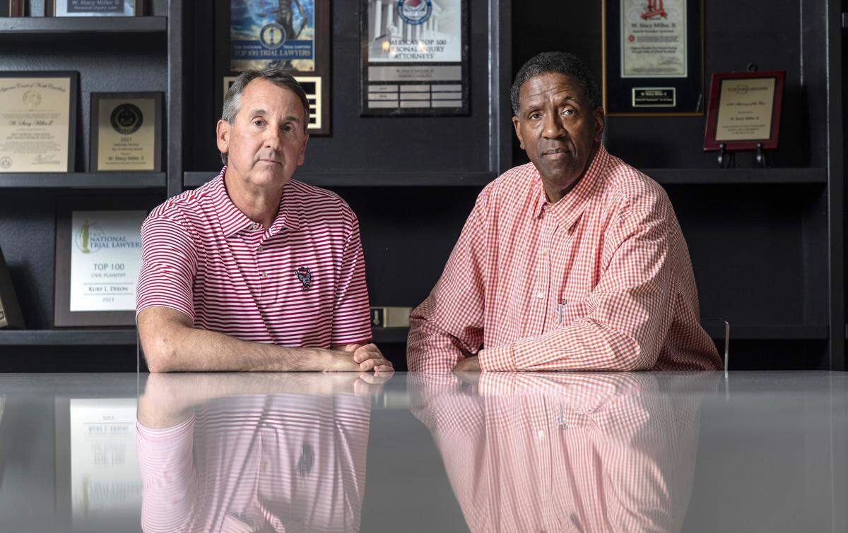 Mike Warren and Cozell McQueen pose at the office of Miller Law Group in Raleigh, N.C., Monday, June 10, 2024. Warren and McQueen are part of a group of players from N.C. State’s 1983 national championship basketball team who are suing the NCAA for using their name, image and likeness without their permission or providing compensation, citing the 2021 Supreme Court antitrust case against the governing body.