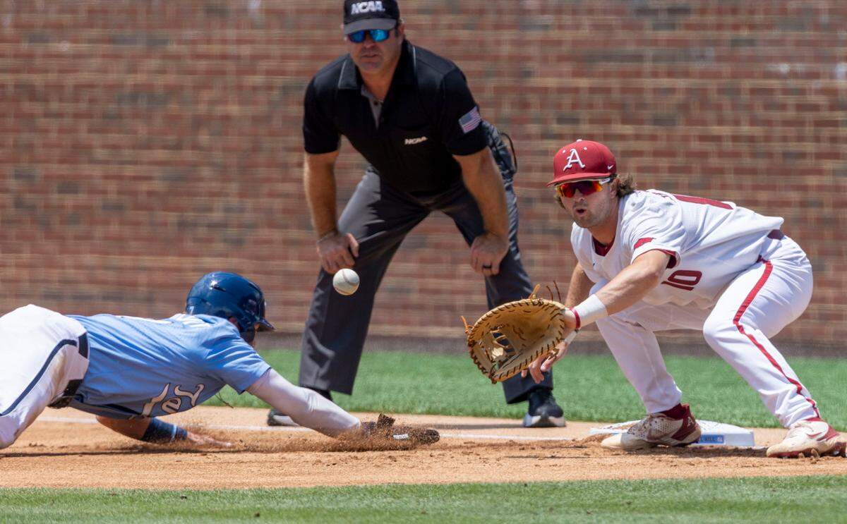 North Carolinas Vance Honeycutt (7) beats the throw by Arkansas pitcher Will McEntire (41) to first baseman Peyton Stovall (10) in the first inning during game two of their NCAA Super Regional series on Sunday, June 12, 2022 at Boshamer Stadium in Chapel Hill, N.C.