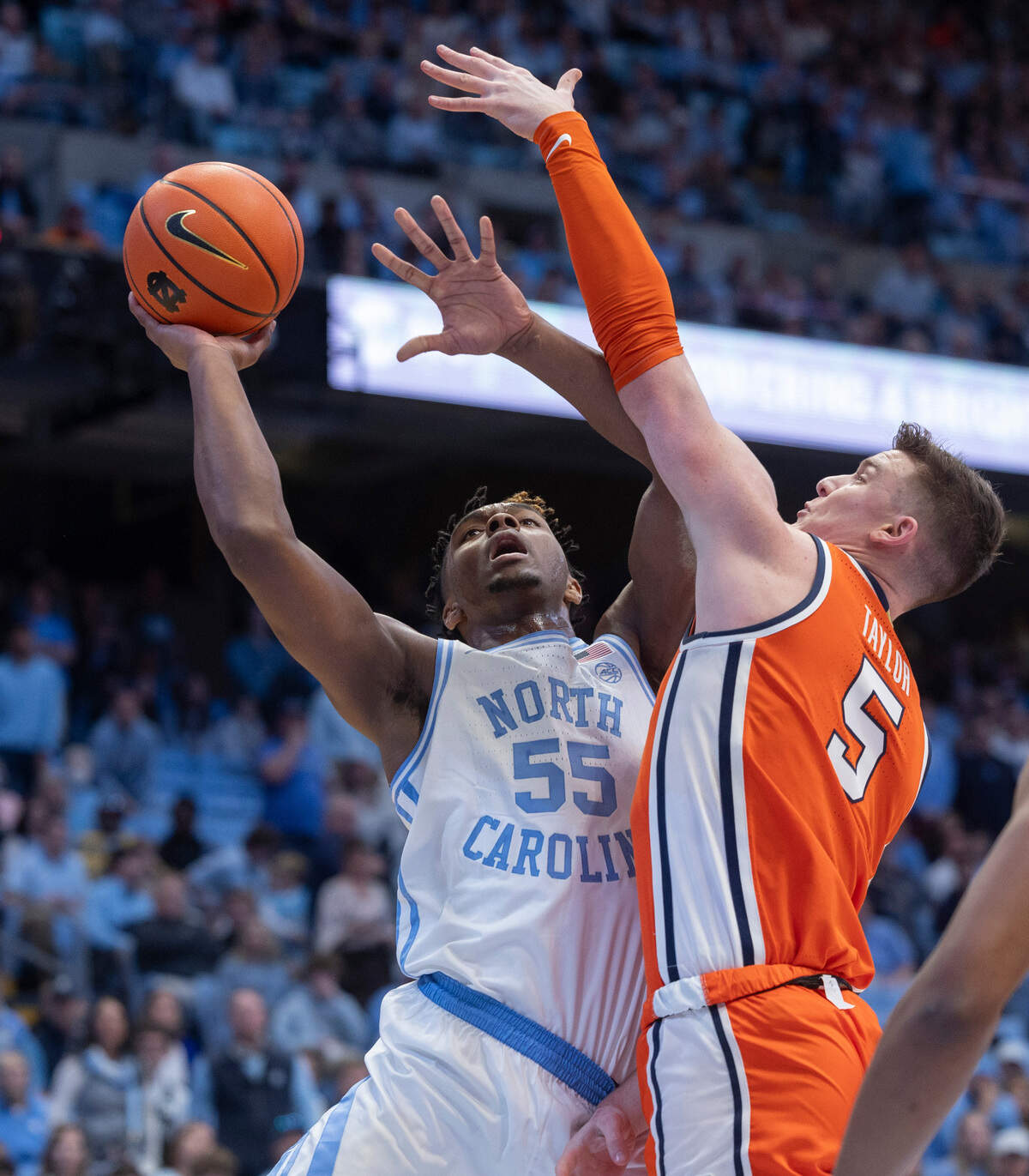 North Carolina’s Harrison Ingram (55) muscles his way to the basket against Syracuse’s Justin Taylor (5) in the first half on Saturday, January 13, 204 at the Smith Center in Chapel Hill, N.C. Ingram scored 11 points in the victory.