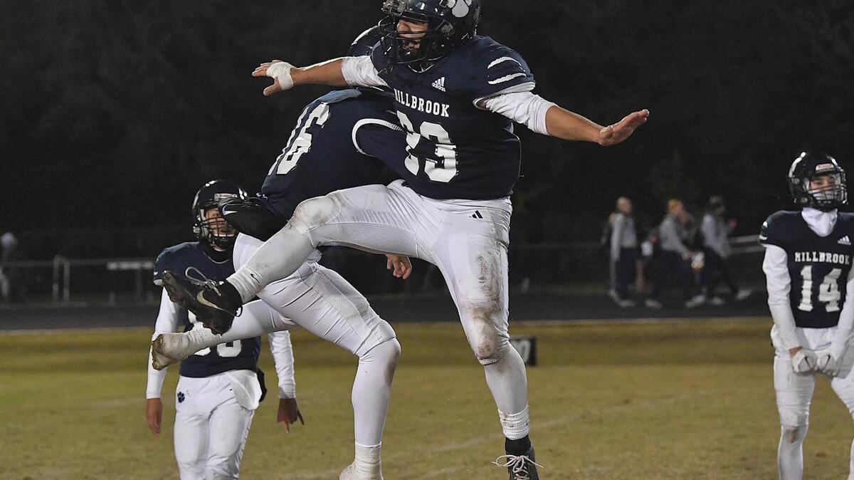 Milbrook’s John Alarcon (23) celebrates with Cowan Myers (6) after their victory over Heritage in the NCHSAA 4A first round playoff game. The Millbrook Wildcats and the Heritage Huskies met in a NCHSAA 4A playoff first round game in Raleigh, N.C. on November 3, 2023.