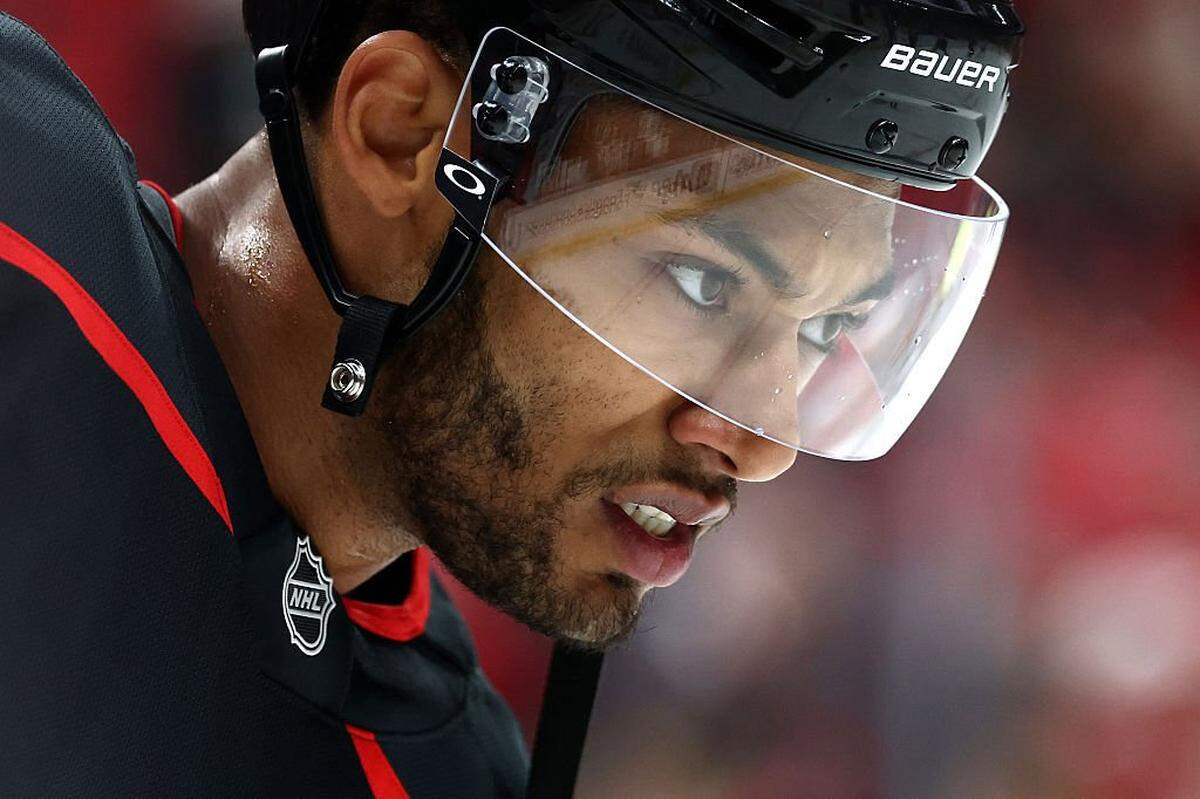 K'Andre Miller of the Carolina Hurricanes looks on prior to the game against the New Jersey Devils at Lenovo Center on October 09, 2025 in Raleigh, North Carolina.