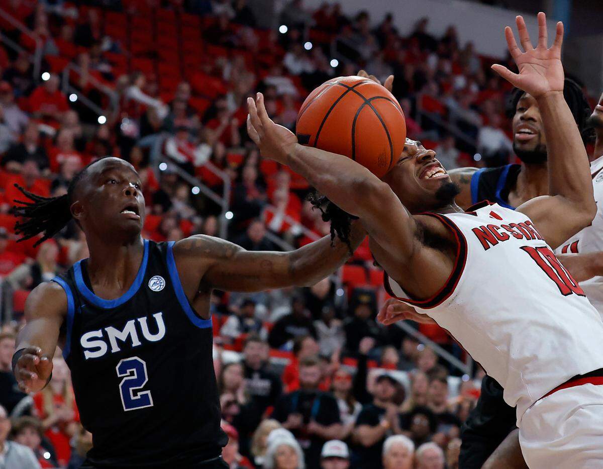 N.C. State’s Marcus Hill battles with Southern Methodist’s Boopie Miller for a rebound during the second half of the Wolfpack’s 63-57 loss on Saturday, Jan. 25, 2025, at Lenovo Center in Raleigh, N.C.