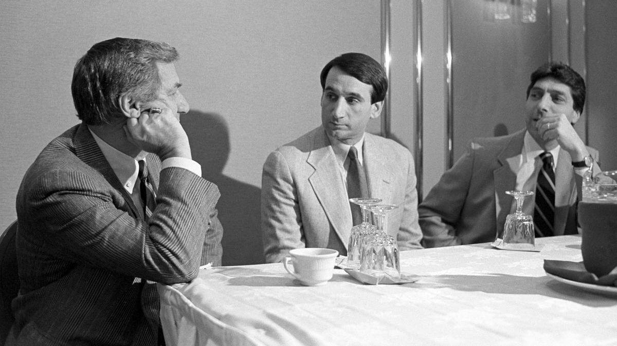Duke basketball coach Mike Krzyzewski (center) and N.C. State basketball coach Jim Valvano listen as UNC coach Dean Smith talks with them before a preseason press conference in 1987.