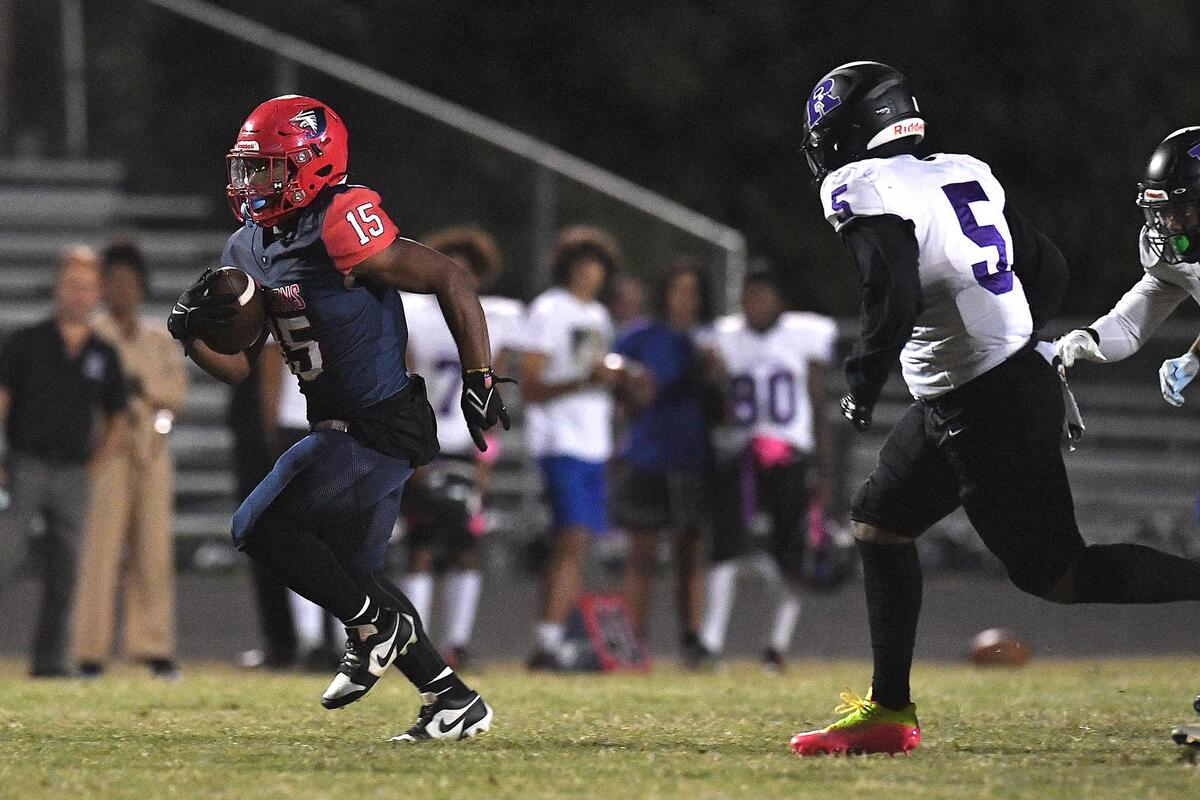 Jordan’s Amareon Blue (15) runs for the touchdown ahead of Riverside’s Jaylen Hargroves (5) in the first quarter. The Riverside Pirates and the Jordan Falcons met in a conference football game in Durham, N.C. on October 13, 2023.