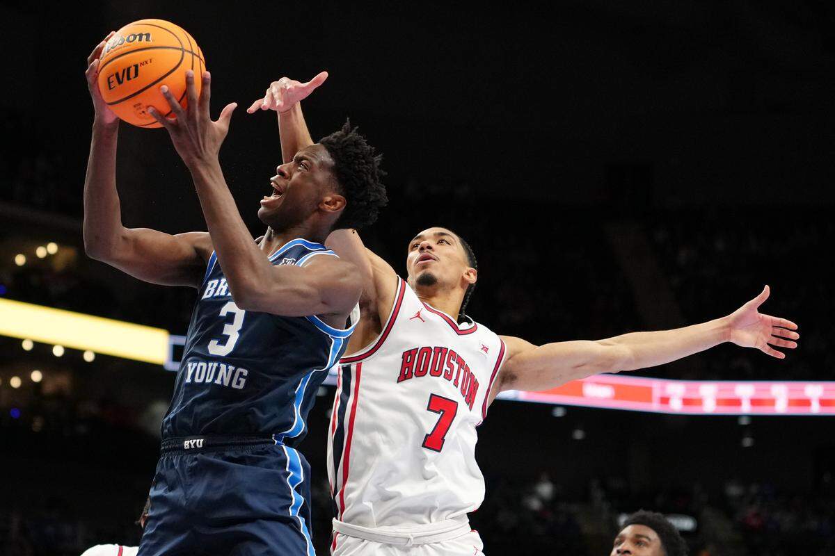 AJ Dybantsa (3) of the BYU Cougars goes up for a shot against Milos Uzan of the Houston Cougars in the first half of the teams’ Big 12 Tournament quarterfinal at T-Mobile Center on March 12, 2026 in Kansas City, Missouri.