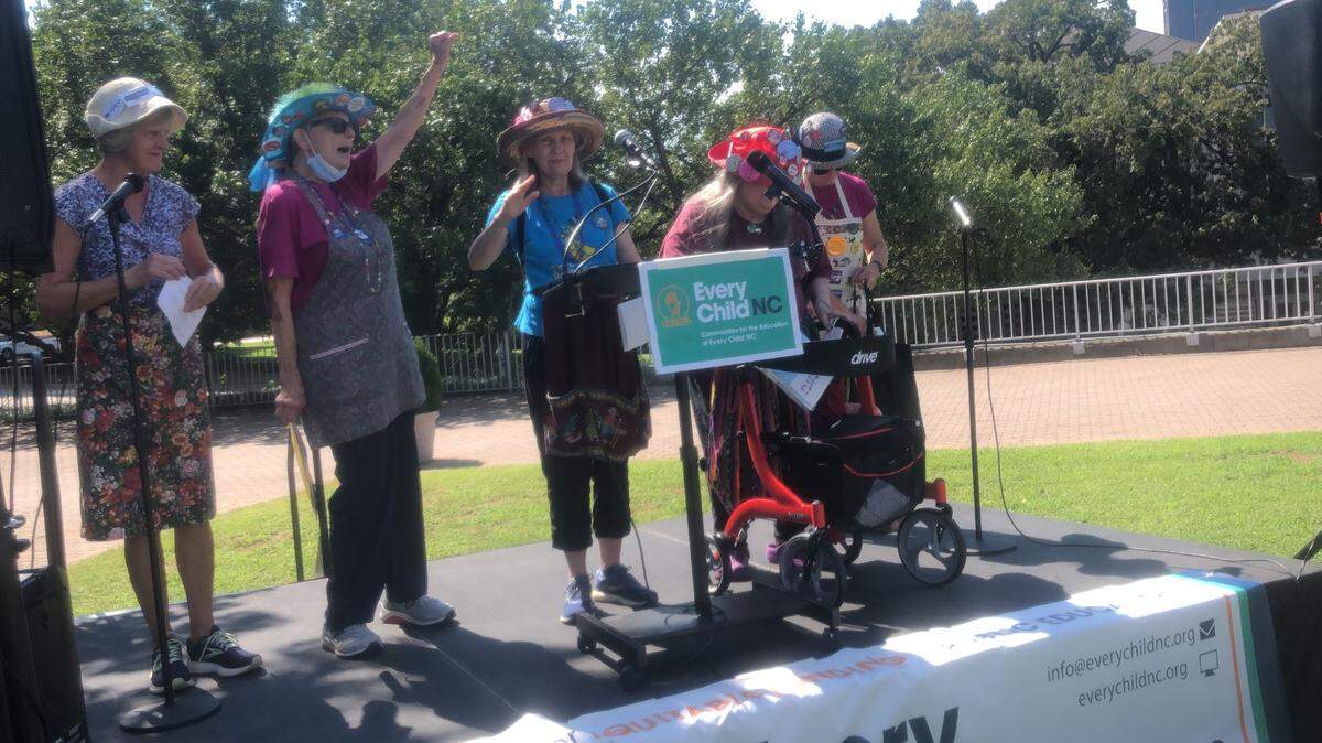 Members of the Triangle chapter of “Raging Grannies” sing a song calling on North Carolina leaders to fully fund the Leadnro education plan at a rally held Aug. 27, 2022 on the Halifax Mall in Raleigh, N.C.