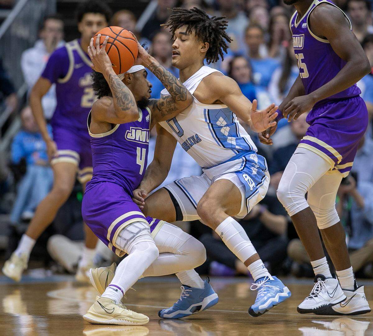 North Carolina’s Seth Trimble (0) defends James Madison’s Vado Morse (4) in the first half on Sunday, November 20, 2022 at the Smith Center in Chapel Hill, N.C.