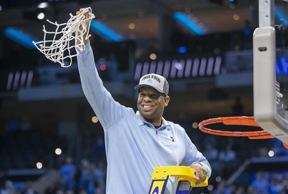 North Carolina coach Hubert Davis cuts down the net following their 69-49 victory over Saint Peters in the NCAA East Regional Championship game on Sunday, March 27, 2022 at Wells Fargo Center in Philadelphia, Pa.