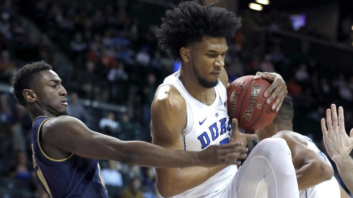 Duke's Marvin Bagley III (35) pulls in a rebound from Notre Dame's TJ Gibbs Jr. (10) during the first half.