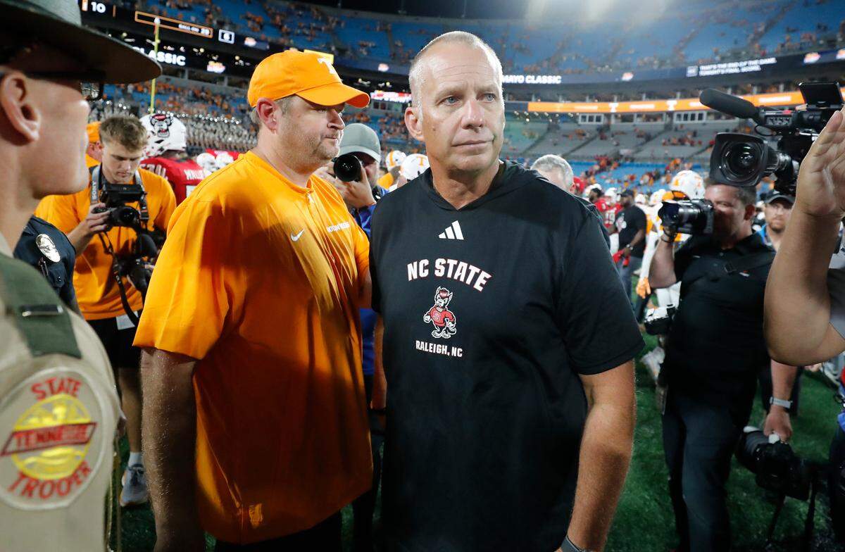 N.C. State head coach Dave Doeren walks away after congratulating Tennessee head coach Josh Heupel after Tennessee’s 51-10 victory over N.C. State in the Duke’s Mayo Classic at Bank of America Stadium in Charlotte, N.C., Saturday, Sept. 7, 2024.