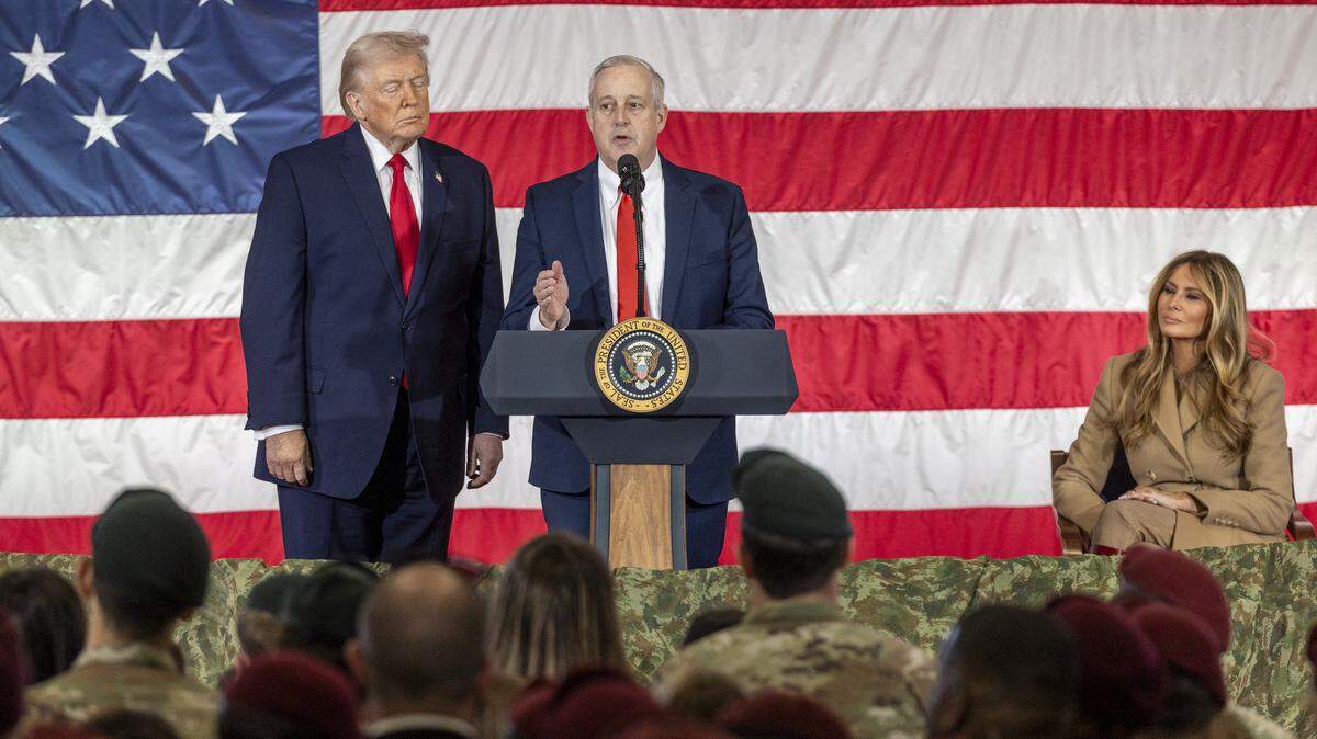 Republican U.S. Senate primary candidate Michael Whatley, center, who is endorsed by President Donald Trump, speaks alongside the president to soldiers from the XVIII Airborne Corps as first lady Melania Trump looks on at Fort Bragg in Fayetteville Friday, Feb. 13, 2026.