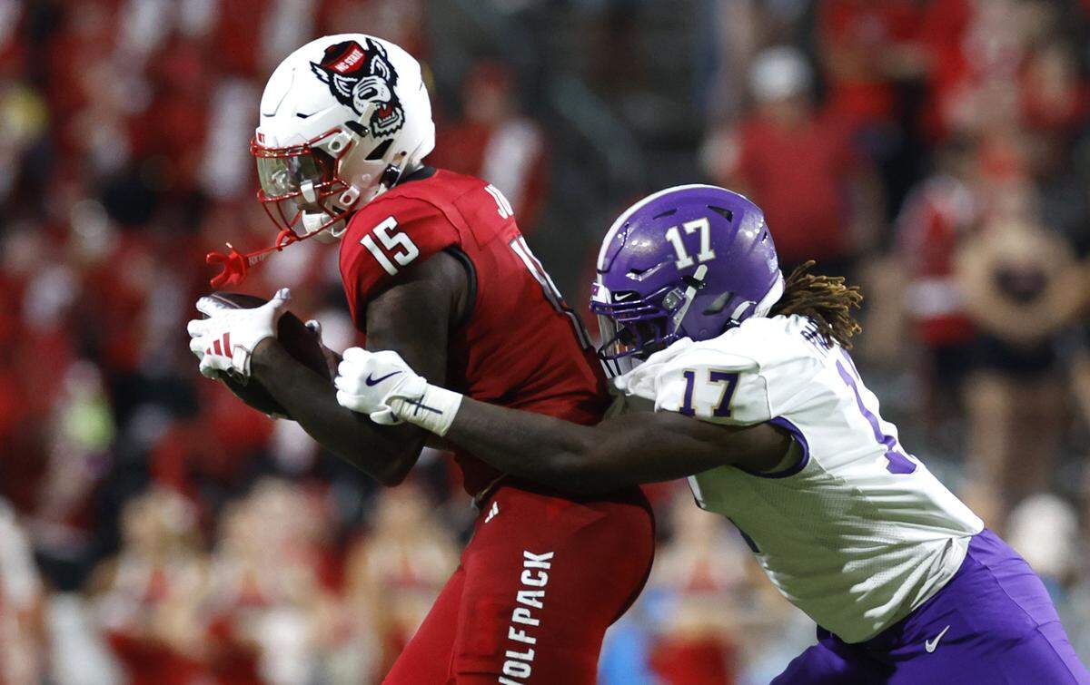 N.C. State tight end Justin Joly (15) makes the reception in front of Western Carolina defensive end Kenyon Partridge (17) during the second half of N.C. State’s 38-21 victory over Western Carolina at Carter-Finley Stadium in Raleigh, N.C., Thursday, August 29, 2024.