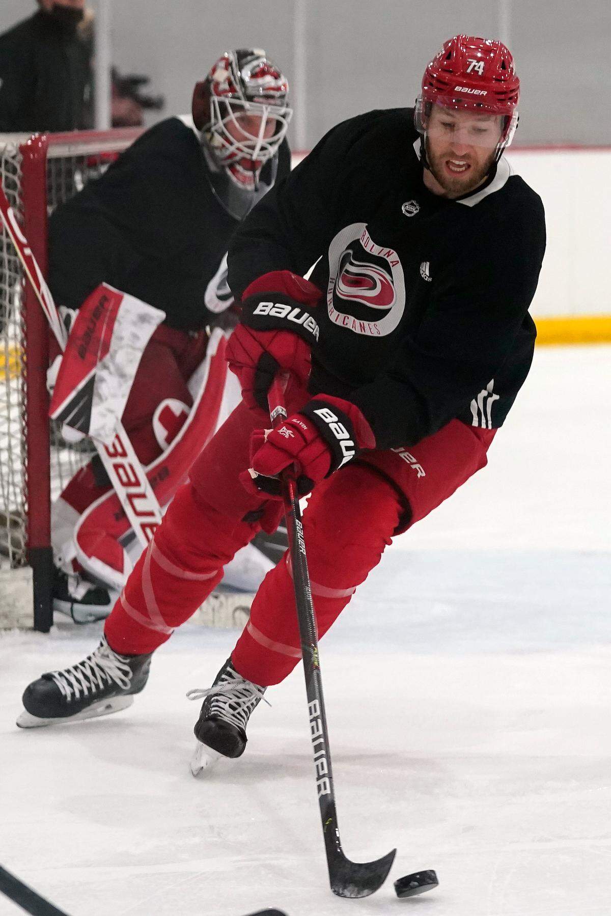 Carolina Hurricanes’ Jaccob Slavin (74) skates during NHL hockey training camp in Morrisville, N.C., Wednesday, Jan. 6, 2021. (AP Photo/Gerry Broome)