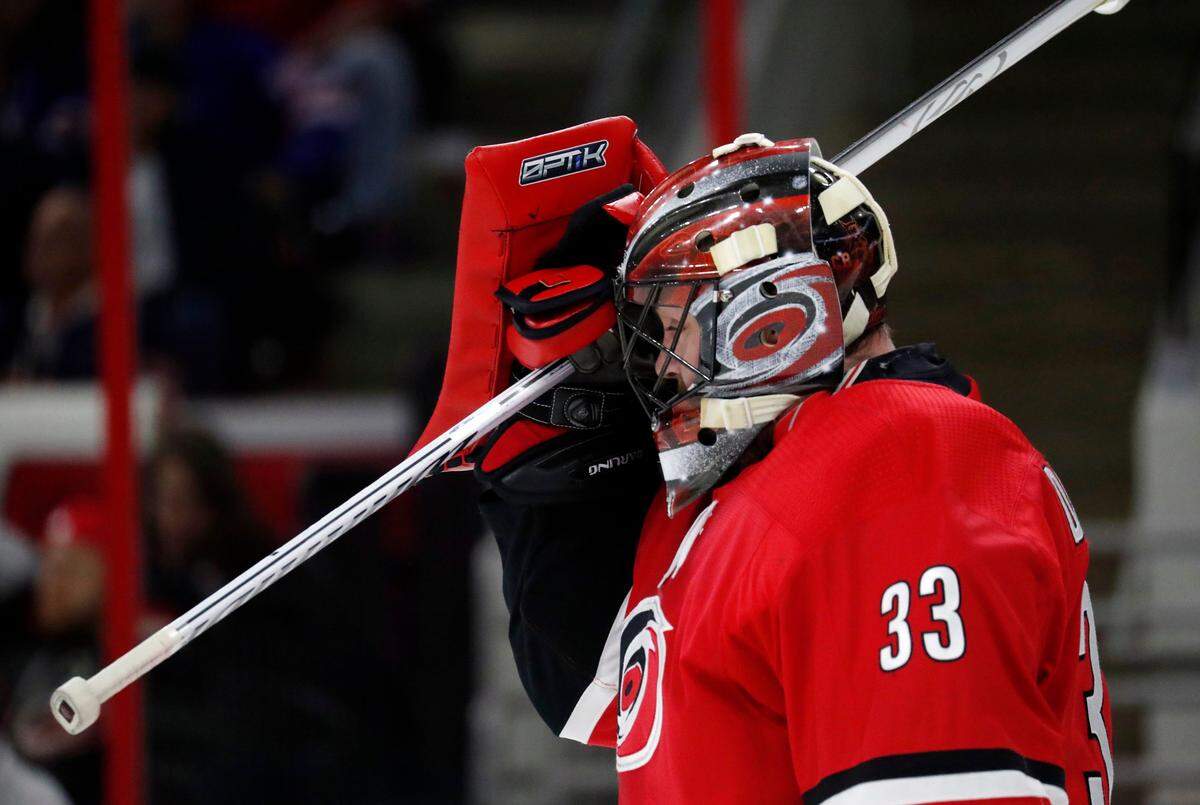 The Canes' Scott Darling (33) reacts after bobbling a catch for the Rangers second goal during the first period of an NHL game played between the Carolina Hurricanes and the NY Rangers at PNC Arena in Raleigh, N.C. on Nov. 22,  2017.  The Rangers beat the Hurricanes 6-1.