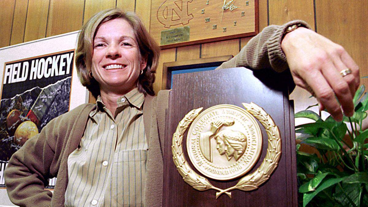 UNC field hockey coach Karen Shelton poses with the National Championship trophy in 1996.