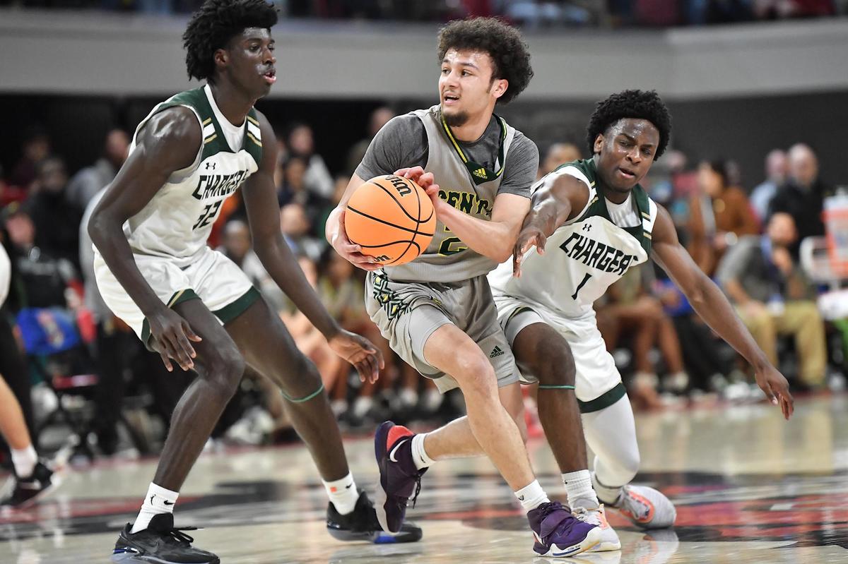 Central Cabarrus’ Carson Daniel (24) looks to pass the ball in the backcourt against Northwood’s Drake Powell (32) and Ashton Elliott (1). The Northwood Chargers and the and the Central Cabarrus Vikings met in the NCHSAA 3A Championship Game in Raleigh, NC on March 11, 2023.