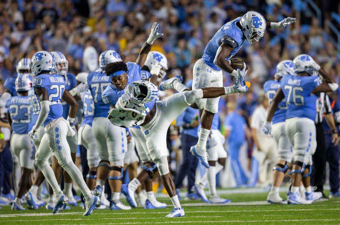 North Carolina’s Don Chapman (2) celebrates with teammate Tyler Thompson (40) with after intercepting a pass by Appalachian State quarterback Joey Aguilar (4) in the third quarter on Saturday September 9, 2023 at Kenan Stadium in Chapel Hill, N.C.