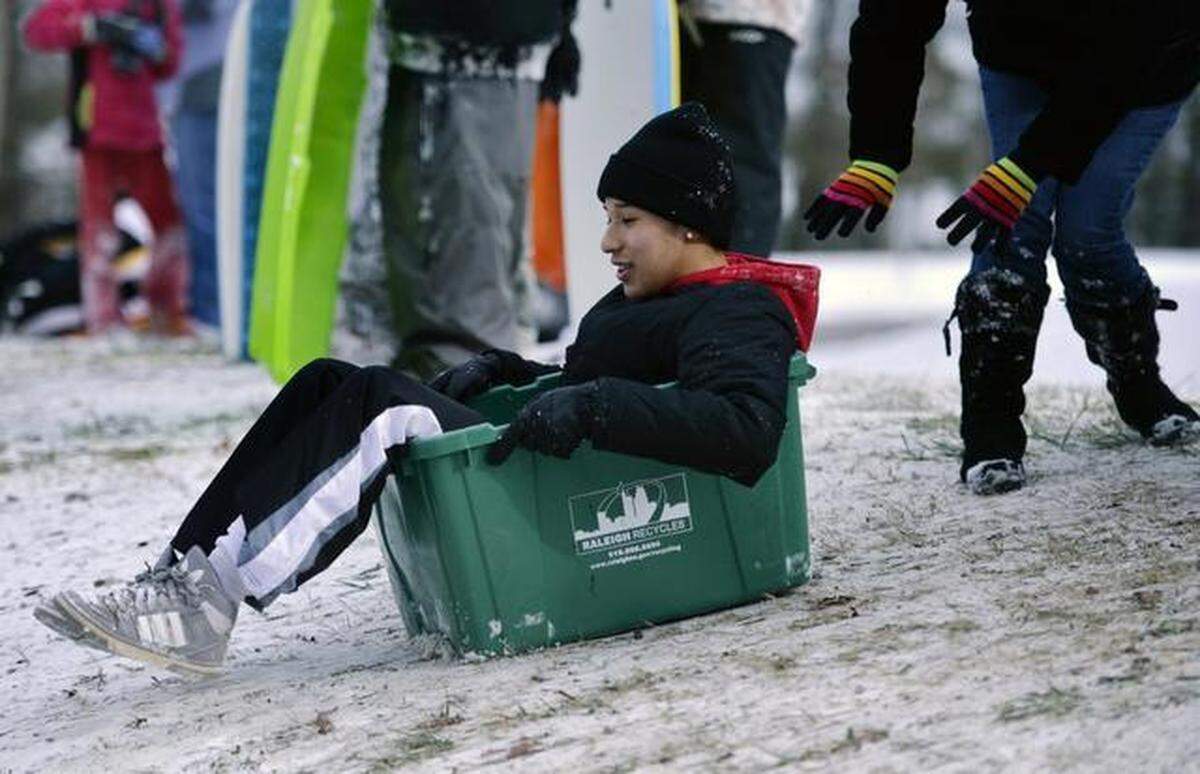 Victor Zavala, 15, uses an abandoned Raleigh recycling bin as an improvised sled at Dix Hill in Raleigh, NC Wednesday afternoon, January 29, 2014.