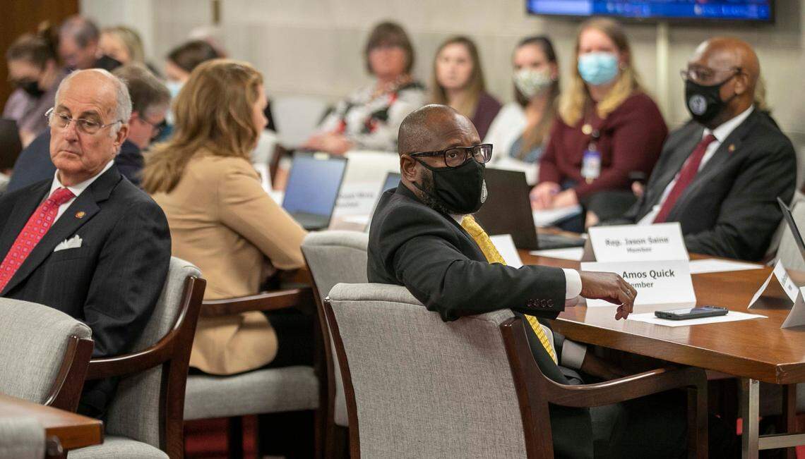 Rep. Amos Quick, right, listens as attorney Dawn Blagrove speaks before the House Rules Committee at the General Assembly on Wednesday, November 17, 2021 in Raleigh, N.C.