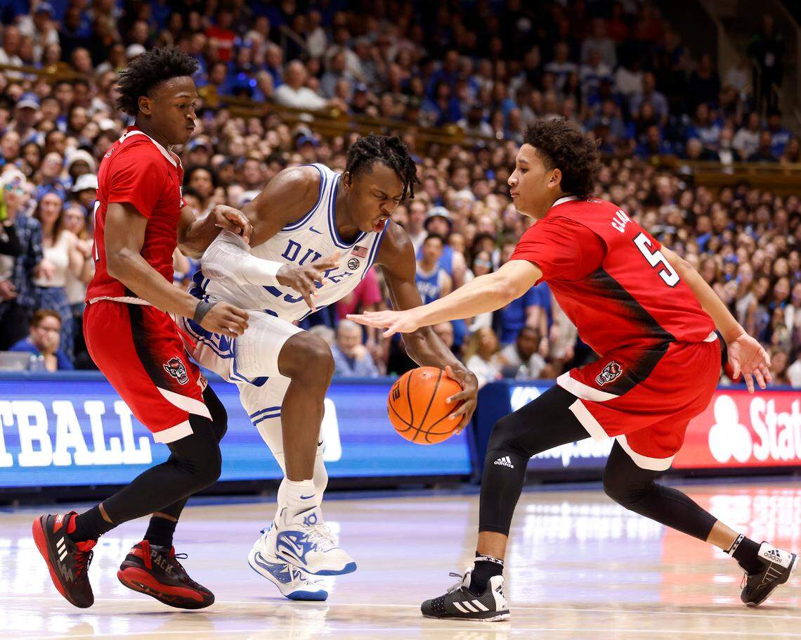 Duke’s Mark Mitchell drives between N.C. State’s Jarkel Joiner and Jack Clark during the second half of Duke’s 71-67 win over N.C. State on Tuesday, Feb. 28, 2023, at Cameron Indoor Stadium in Durham, N.C.