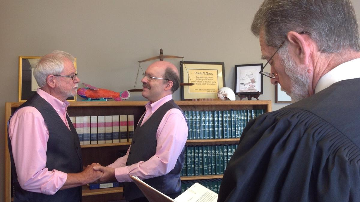 Tom Attaway, left, with Chuck Small at the Raleigh couple’s 2014 wedding in the San Juan Islands. Small is a lifelong Catholic who has stayed in the church despite its official position on same-sex marriage.