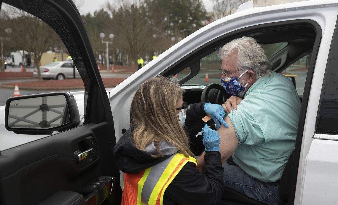 Larry Elmore receives his COVID-19 vaccination during a Wake County mass vaccination clinic on Thursday, February 11, 2021 at PNC Arena in Raleigh, N.C. Wake County Public Health is collaborating with area hospitals and a consortium of providers for the three day appointment only drive-thru clinic.