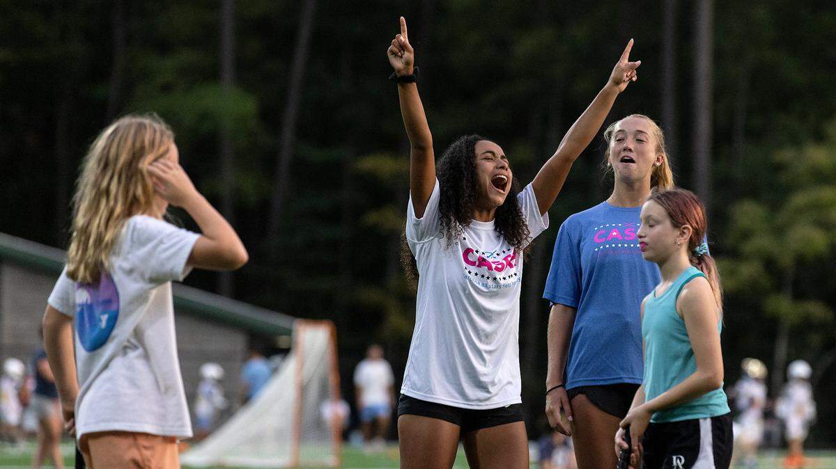 Kiersten Thomassey reacts while coaching young athletes during a fall academy event held by Carolina All Stars Field Hockey on Wednesday, Sept. 13, 2023, at Cedar Falls Park in Chapel Hill, N.C.