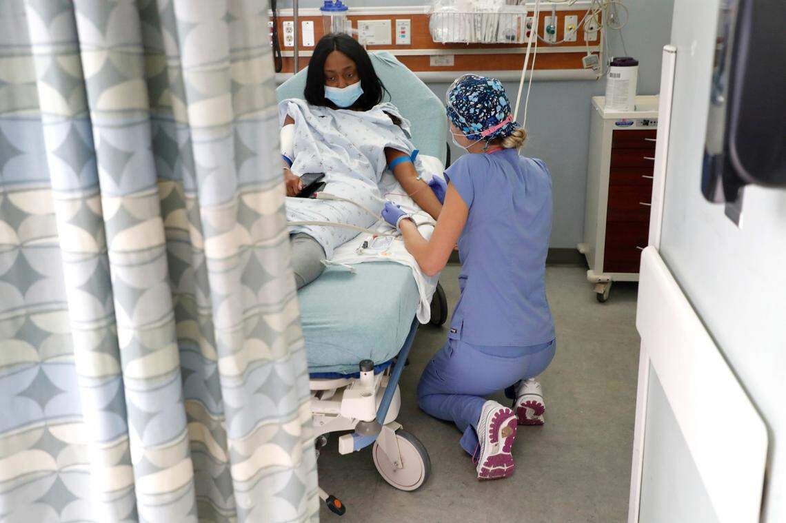 Erica South, a nurse in the emergency department, helps DeTyah Cook at UNC REX Hospital in Raleigh, NC on Oct. 1, 2021.