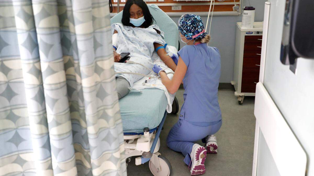 Erica South, a nurse in the emergency department, helps DeTyah Cook at UNC REX Hospital in Raleigh, NC on Oct. 1, 2021.