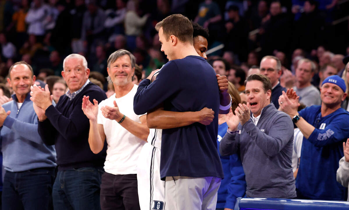 Duke head coach Jon Scheyer hugs Jeremy Roach (3) as he comes off the court late in the second half of Duke’s 78-70 victory over Baylor at Madison Square Garden in New York City Wednesday, Dec. 20, 2023.