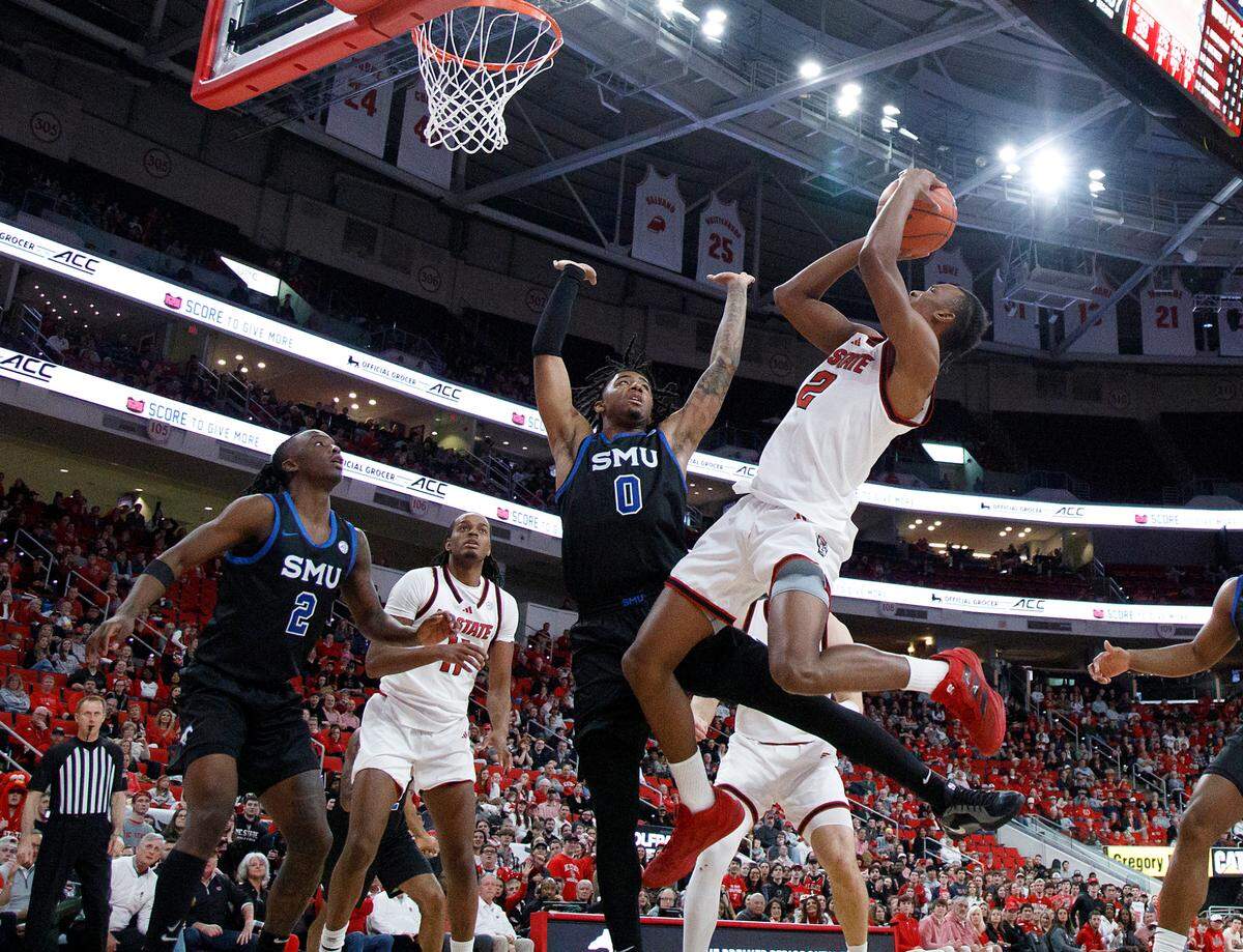 N.C. State’s Paul McNeil shoots over Southern Methodist’s B.J. Edwards during the second half of the Wolfpack’s 63-57 loss on Saturday, Jan. 25, 2025, at Lenovo Center in Raleigh, N.C.