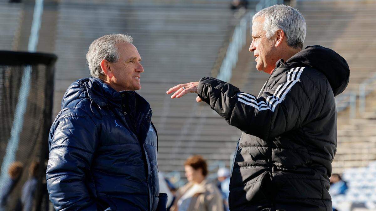 North Carolina athletic director Bubba Cunningham talks with N.C. State athletic director Boo Corrigan before N.C. State’s game against UNC at Kenan Stadium in Chapel Hill, N.C., Saturday, Nov. 30, 2024.
