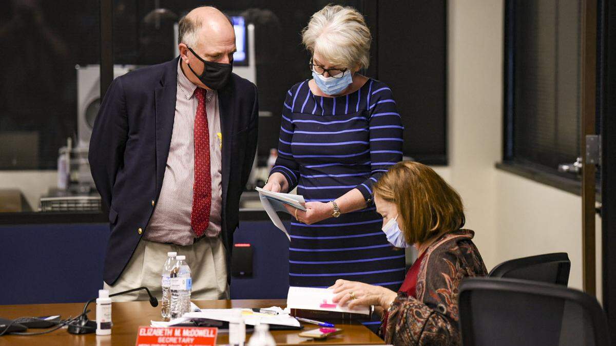 Mecklenburg County Board of Elections Director Michael Dickerson, left, speaks with a member of the board about a group of ballots they were examining and counting on Friday, November 6, 2020.
