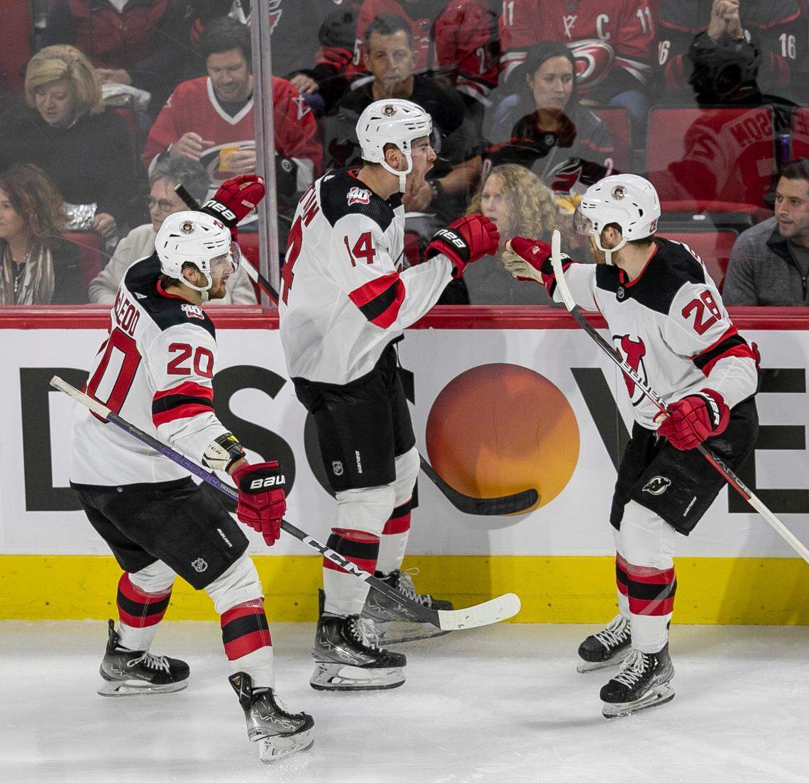 The New Jersey Devils Nathan Bastian (14) celebrates with teammates Damon Severson (28) and Michael McLeod (20) after scoring in the second period against the Carolina Hurricanes during Game 1 of their second round Stanley Cup playoff series on Wednesday, May 3, 2023 at PNC Arena in Raleigh, N.C.