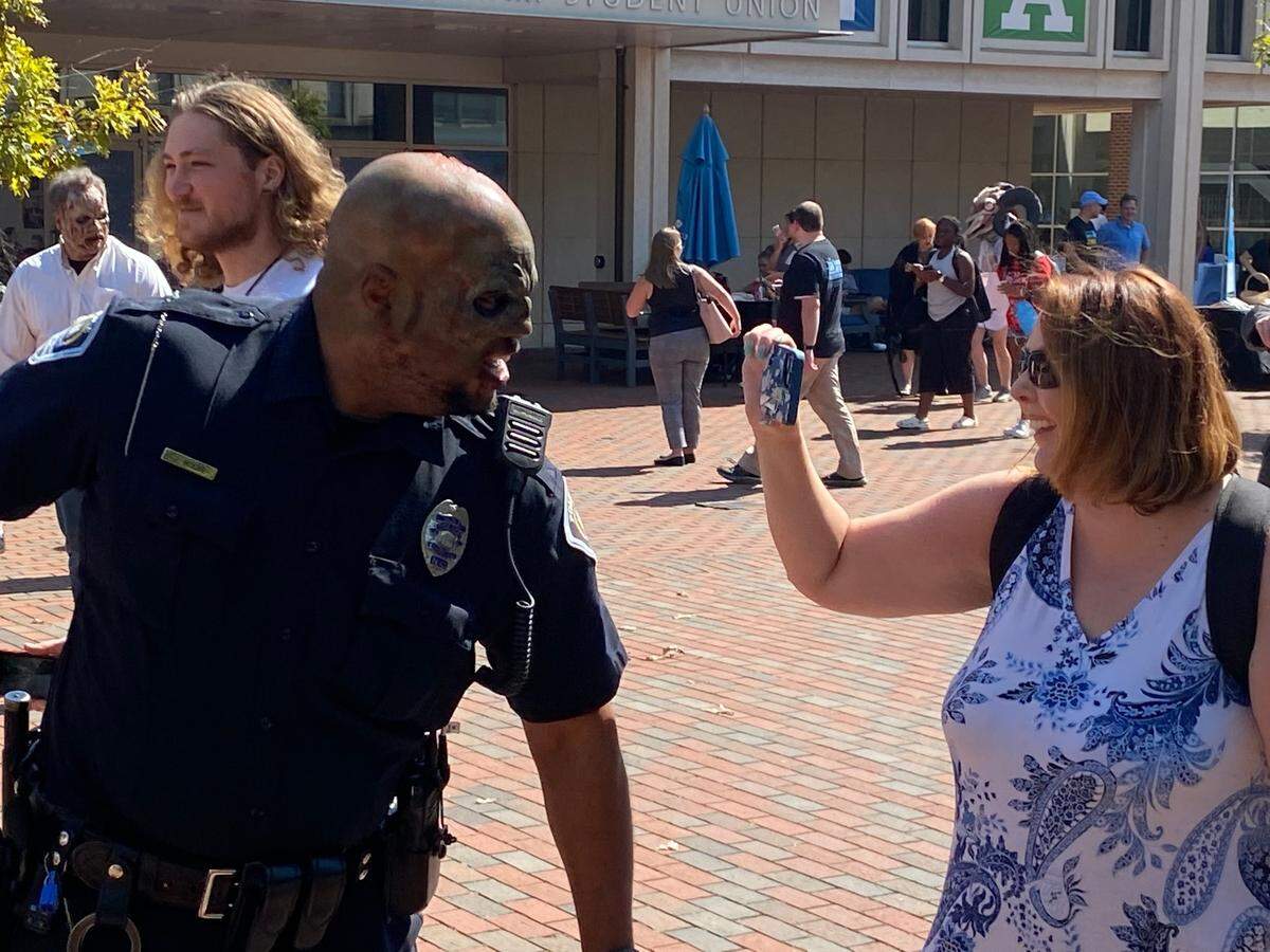 A UNC-Chapel Hill police officer joins the zombie-related festivities during a multi-agency demonstration of camus safety practices Thursday.