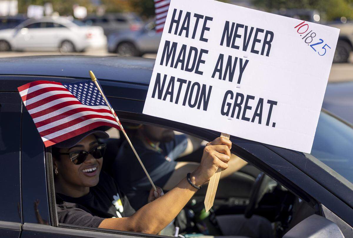 Demonstrators in cars cruise along Capital Blvd. interacting with those lining the road during the ‘No Kings’ protest on Saturday, October 18, 2025 in Raleigh, N.C