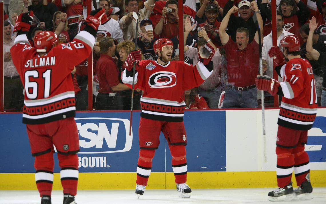 Cory Stillman, Frantisek Kaberle (center) and Justin Williams celebrate Kaberle’s second period against the Edmonton Oilers on June 19, 2006 during game 7 of the Stanley Cup Final.
