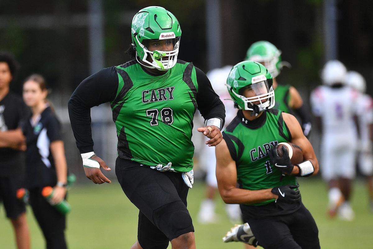 Cary’s Trey Blue (78) in pre-game drills with Adan Knight (1) before their game with Athens Drive. The Cary Imps and the Athens Drive Jaguars met in a football game in Cary, N.C. on September 6, 2024. Athens Drive wins 28-13.