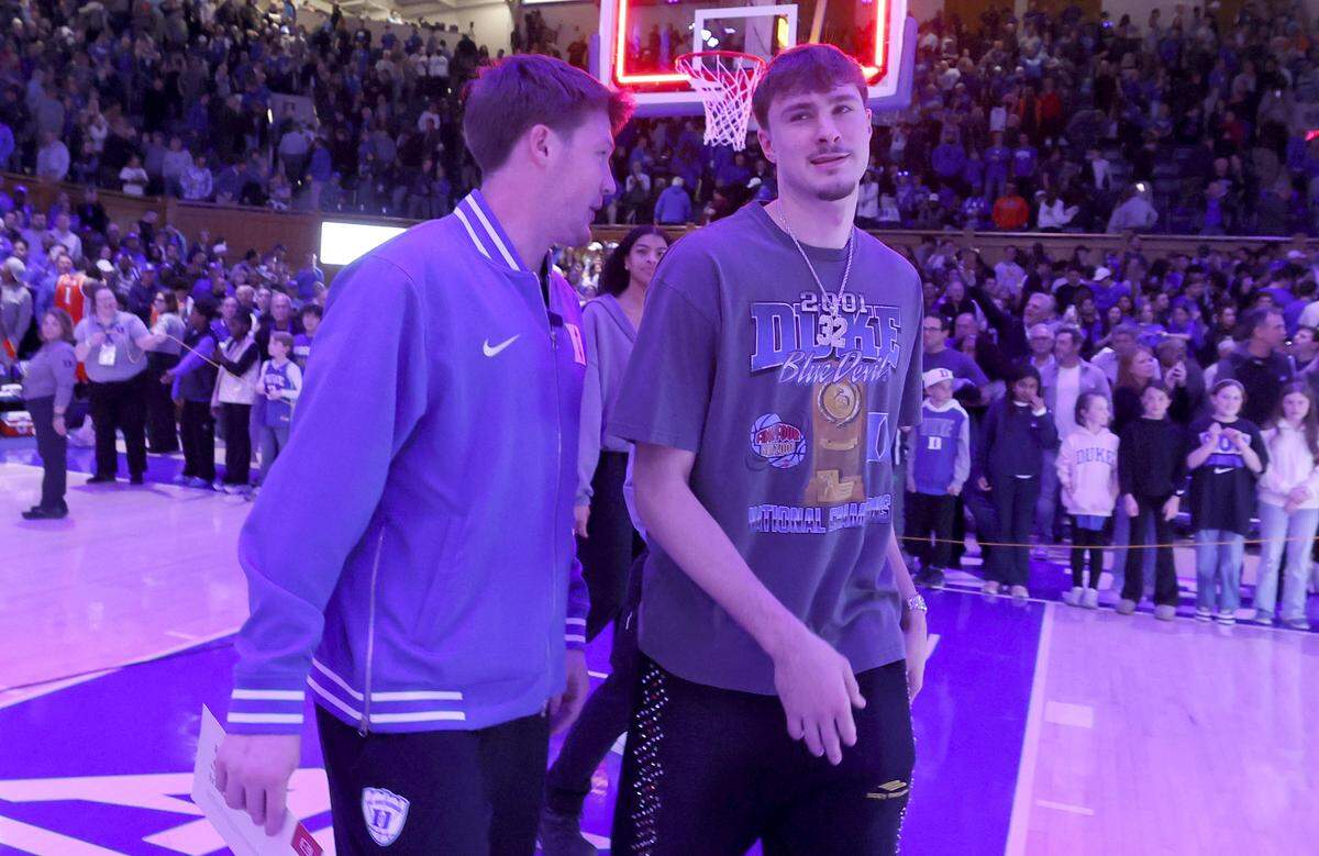 Former Duke stars Kon Knueppel and Cooper Flagg talk as they head off the court after Duke’s 101-64 victory over Syracuse at Cameron Indoor Stadium in Durham, N.C., Monday, Feb. 16, 2026.